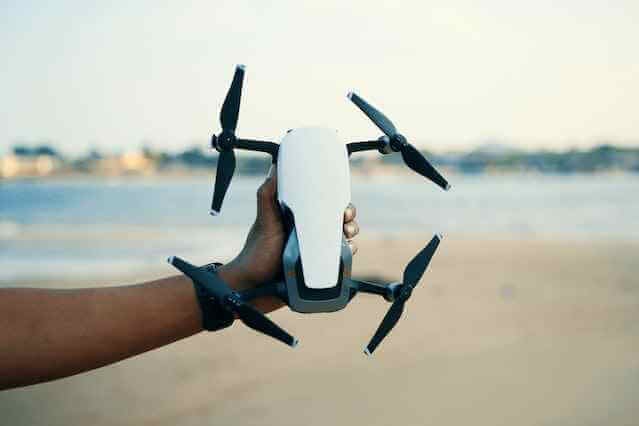 a man holding a drone camera for photography