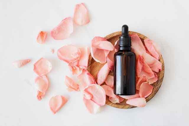 A Perfume bottle on pink rose petals